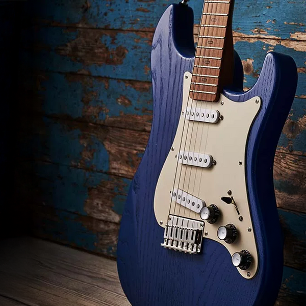Blue electric guitar against a rustic wooden background